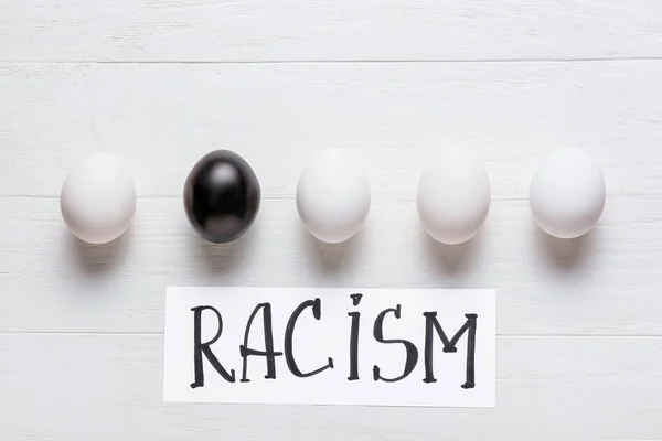 Different Eggs White Wooden Background Racism Concept — Stock Photo, Image