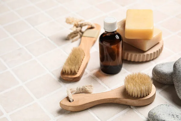 Different Body Brushes Bath Supplies Light Tile Background — Stock Photo, Image