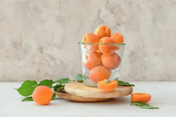 Jar Tasty Ripe Apricots Light Background — Stock Photo, Image