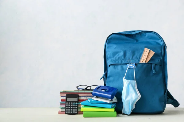 Set Stationery Backpack Medical Mask Light Background — Stock Photo, Image