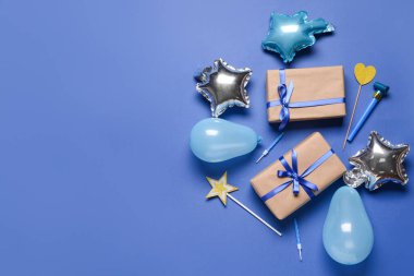 Hediye kutuları, balonlar, mumlar ve renk arkaplanındaki ses çıkarıcı