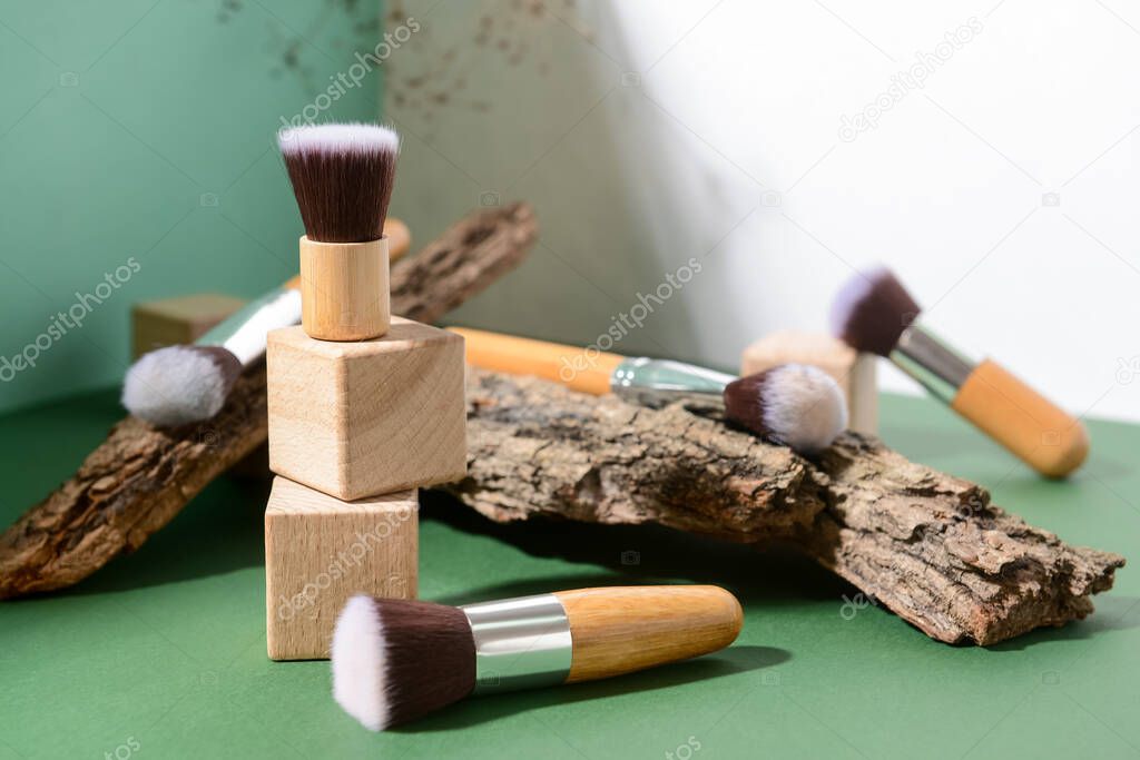 Set of makeup brushes with decor on color background