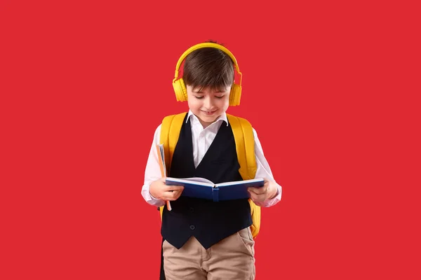 Little Schoolboy Headphones Reading Book Color Background — Stock Photo, Image