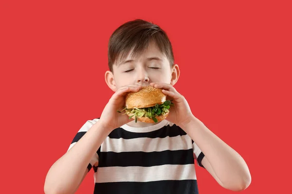 Menino Comendo Saboroso Hambúrguer Vegan Fundo Cor — Fotografia de Stock