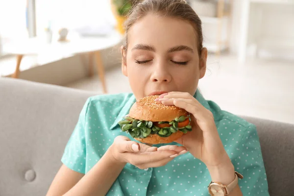 Young Woman Eating Tasty Vegan Burger Home — Stock Photo, Image