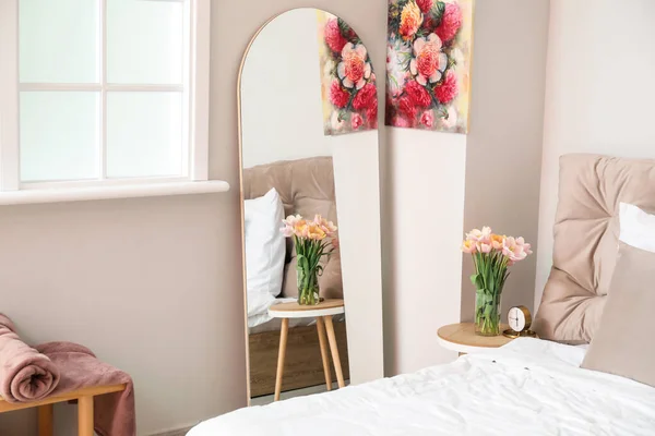 Stylish mirror in interior of bedroom