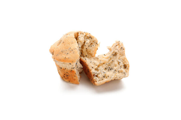 Delicious muffin with poppy seeds broken in pieces on white background