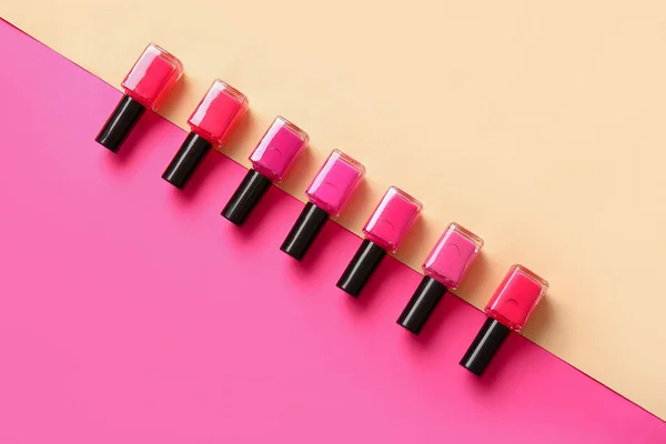 stock image Different nail polishes on color background