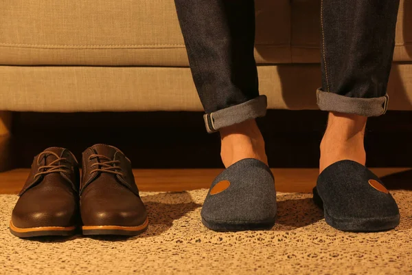 Man wearing soft slippers at home, closeup
