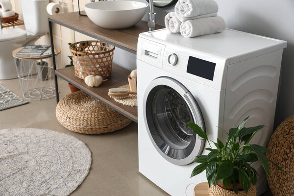 Modern washing machine in bathroom