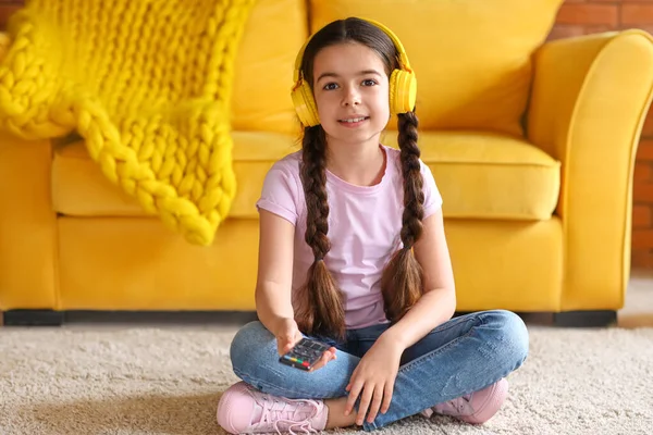 Cute girl watching cartoons at home