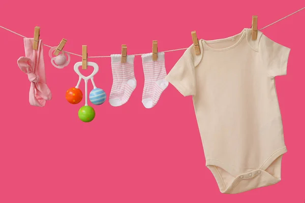 Baby Clothes Accessories Hanging Rope Color Background — Stock Photo, Image