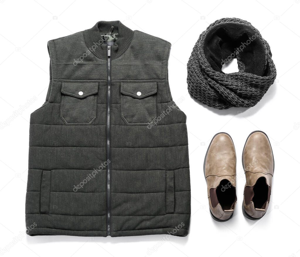 Male vest jacket, knitted scarf and shoes on white background
