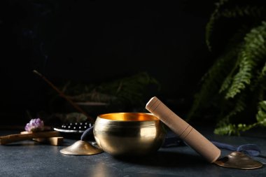 Koyu arkaplanda karatalalar olan Tibet şarkı kasesi