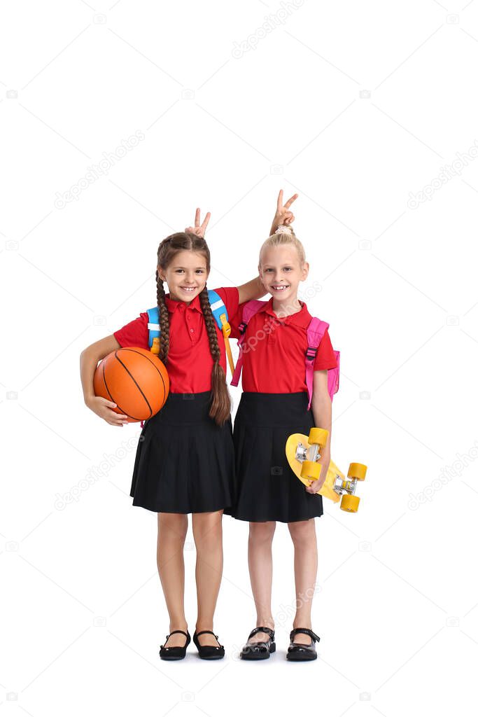 Cute pupils with ball and skateboard on white background