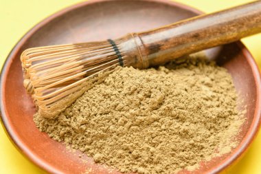 Pudralanmış kibrit çay ile kase ve renkli arka planda chasen, yakın plan