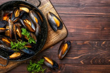 Ahşap arka planda lezzetli midyeli tava, yakın plan.