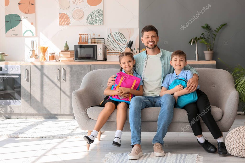 Father with his little children before school