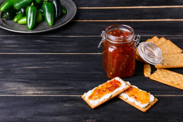 Jar Delicious Jalapeno Pepper Jam Crackers Dark Wooden Background — Stock Photo, Image