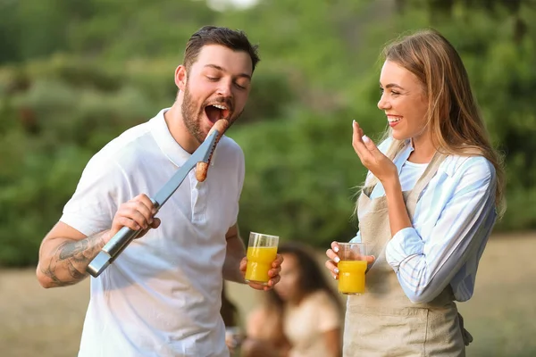 Young Man Eating Grilled Sausage Barbecue Party Summer Day — Stock Photo, Image