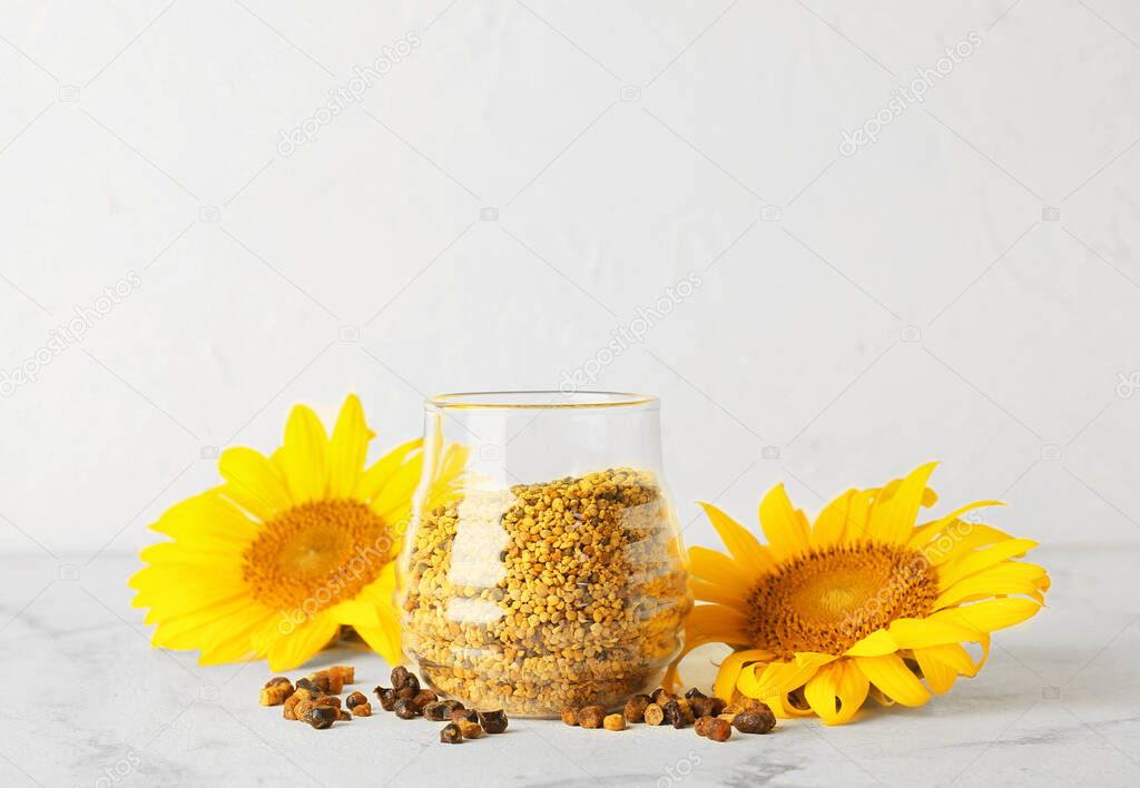 Jar of bee pollen and beebread on white background