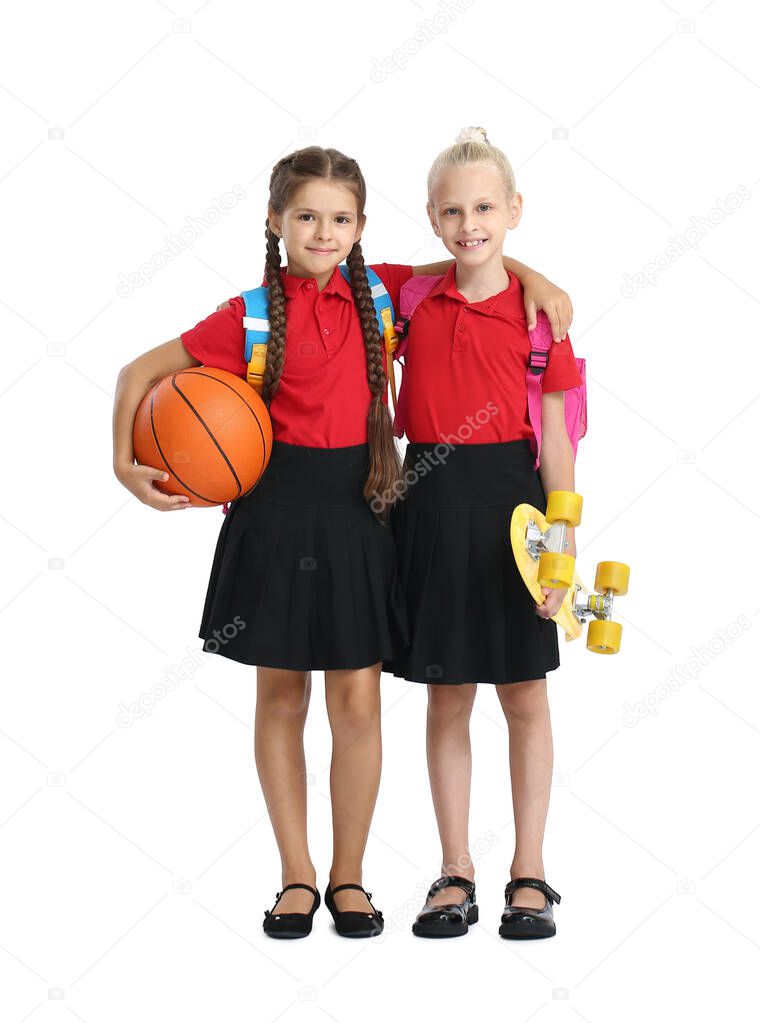Cute pupils with ball and skateboard on white background