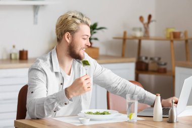 Genç adam evde lezzetli ravioli yiyor.