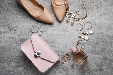 Kadın aksesuarları, ayakkabılar ve bir şişe parfümle yapılmış çerçeve.