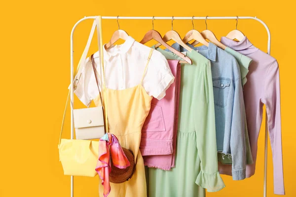 Rack Stylish Clothes Bags Color Background — Stock Photo, Image