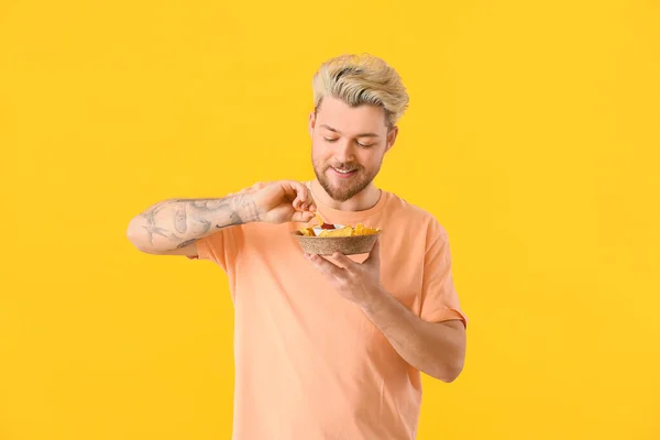 Handsome Young Man Eating Tasty Nachos Color Background — Stock Photo, Image