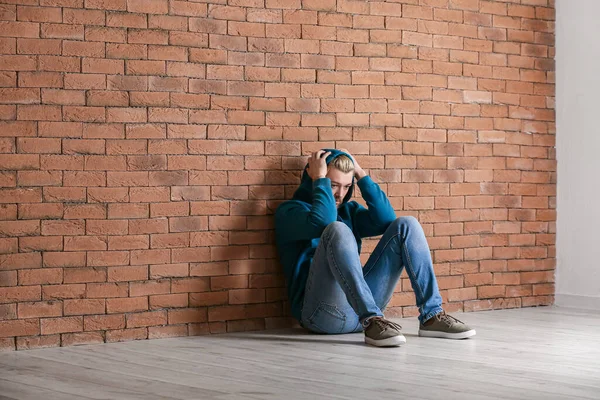 Depressed Young Man Sitting Brick Wall — Stock Photo, Image