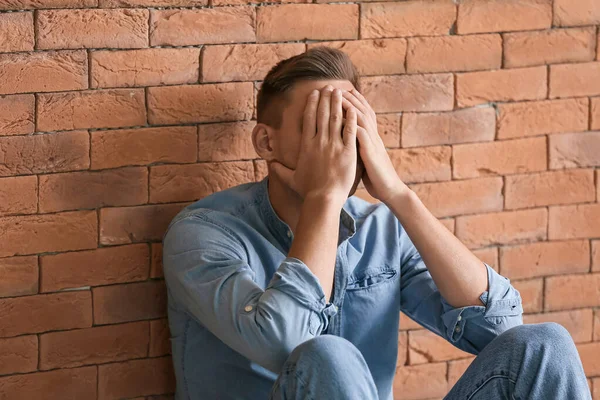 Depressed Young Man Sitting Brick Wall — Stock Photo, Image