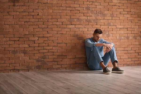 Depressed Young Man Sitting Brick Wall — Stock Photo, Image
