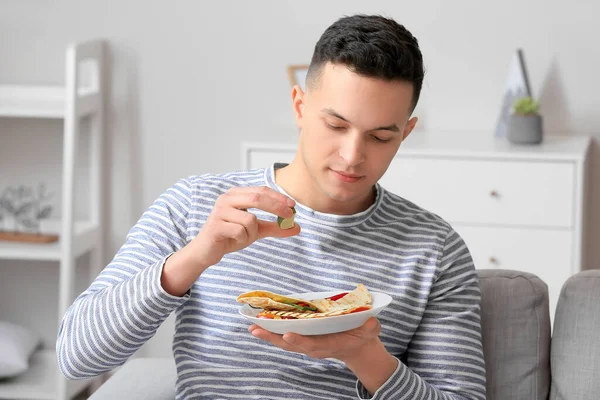 Handsome Young Man Eating Tasty Quesadilla Home — Stock Photo, Image