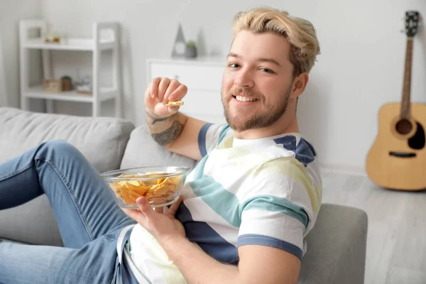 Handsome Young Man Eating Tasty Nachos Home — Stock Photo, Image