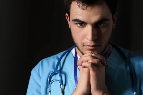 Praying Male Doctor Dark Background — Stock Photo, Image