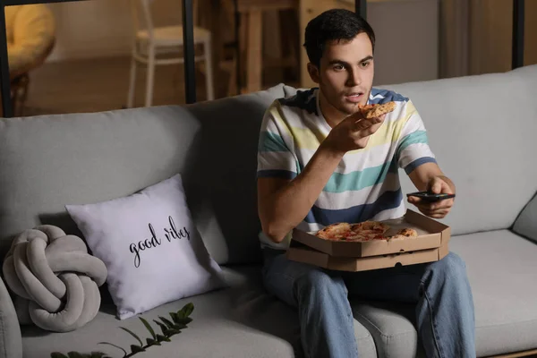 Handsome Young Man Eating Tasty Pizza While Watching Home Evening — Stock Photo, Image