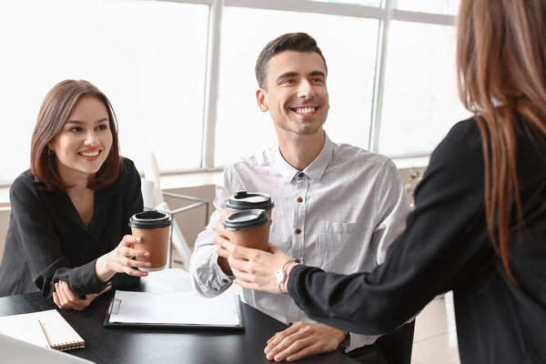 Business colleagues drinking coffee in office