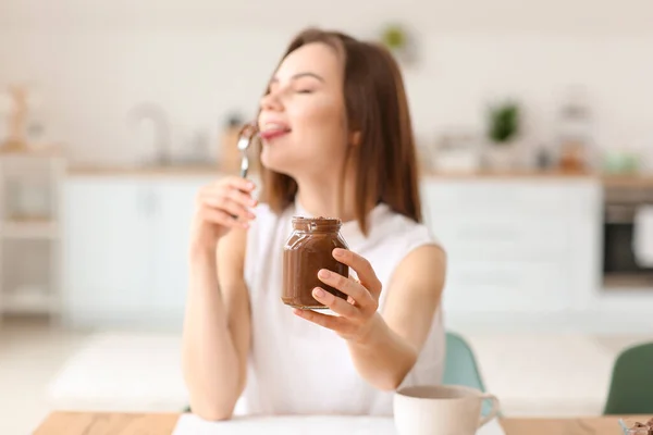 Beautiful Young Woman Eating Tasty Chocolate Paste Home — Stock Photo, Image