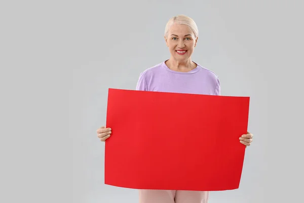 Mature Woman Blank Poster Light Background — Stock Photo, Image