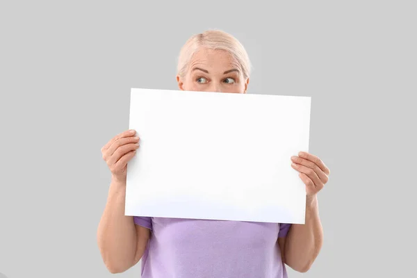 Mature Woman Blank Paper Sheet Light Background — Stock Photo, Image