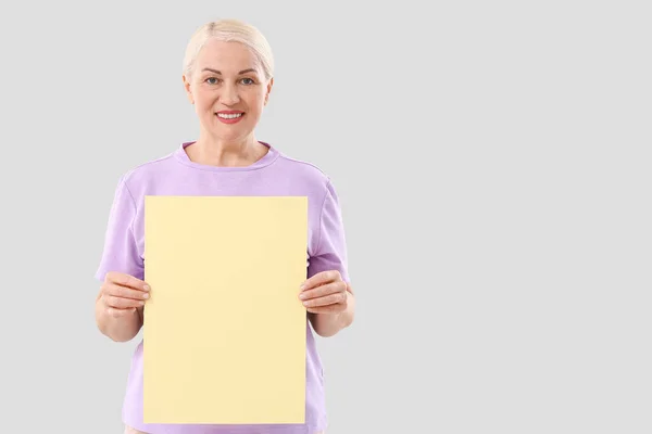 Mature Woman Blank Paper Sheet Light Background — Stock Photo, Image