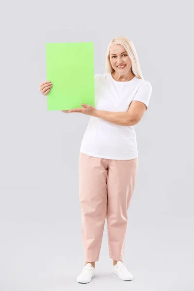 Mature Woman Blank Paper Sheet Light Background — Stock Photo, Image