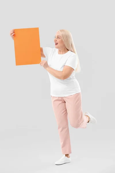 Mature Woman Blank Paper Sheet Light Background — Stock Photo, Image