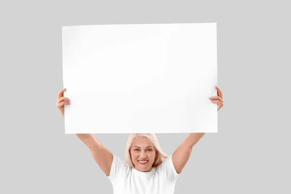 Mature Woman Blank Poster Light Background — Stock Photo, Image