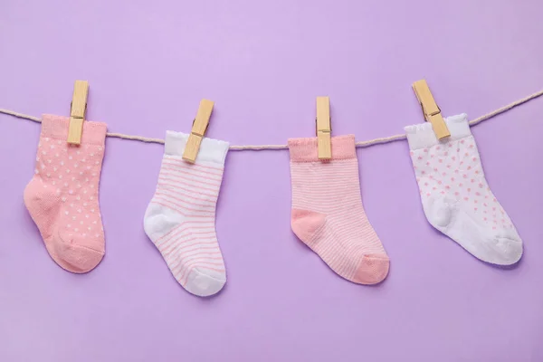 Different Baby Socks Hanging Rope Color Background — Stock Photo, Image