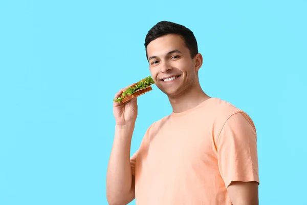 Young Man Tasty Sandwich Color Background — Stock Photo, Image