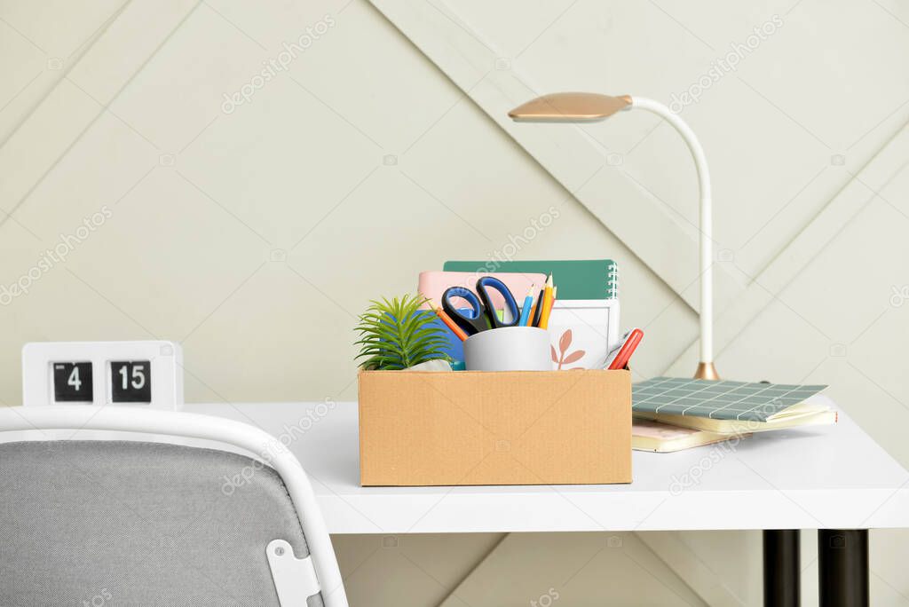 Box with personal stuff on table in office