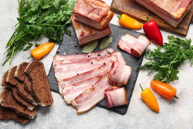 Lezzetli tütsülenmiş pastırma, ekmek ve hafif arkaplanda taze sebzeler.