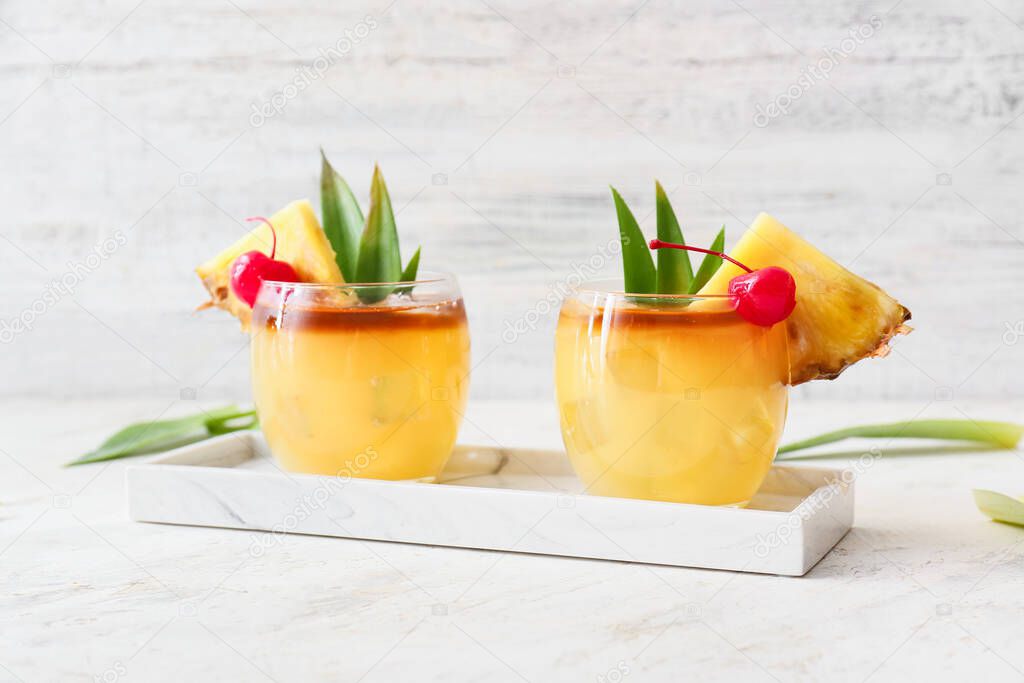 Glasses of tasty mai tai cocktail on table